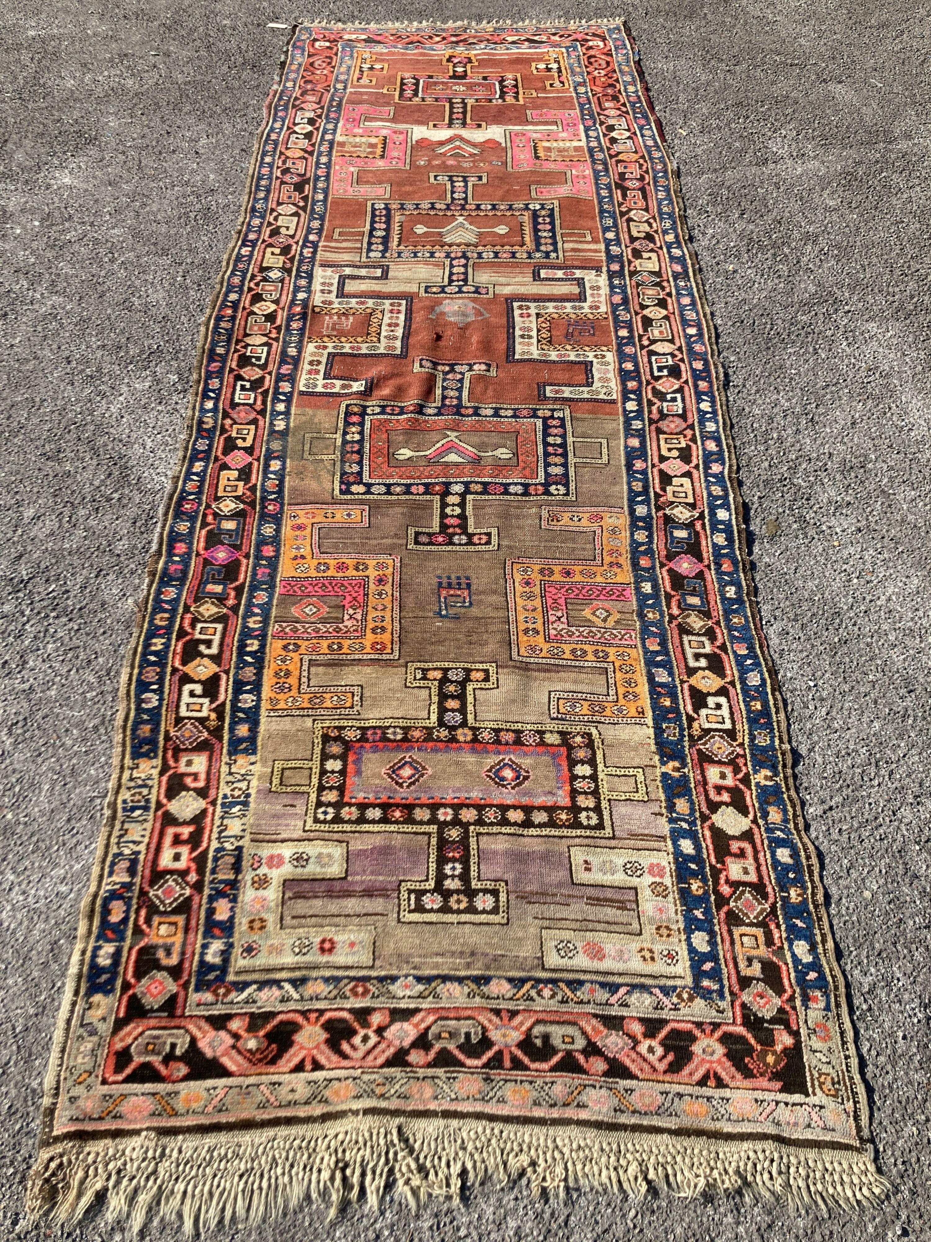 An early 20th century Caucasian Kazak hall carpet, 370 x 128cm